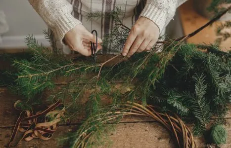 Making,Rustic,Christmas,Wreath.,Female,Hands,Cutting,Fir,Branches,With